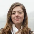 A woman with long hair and a white shirt.