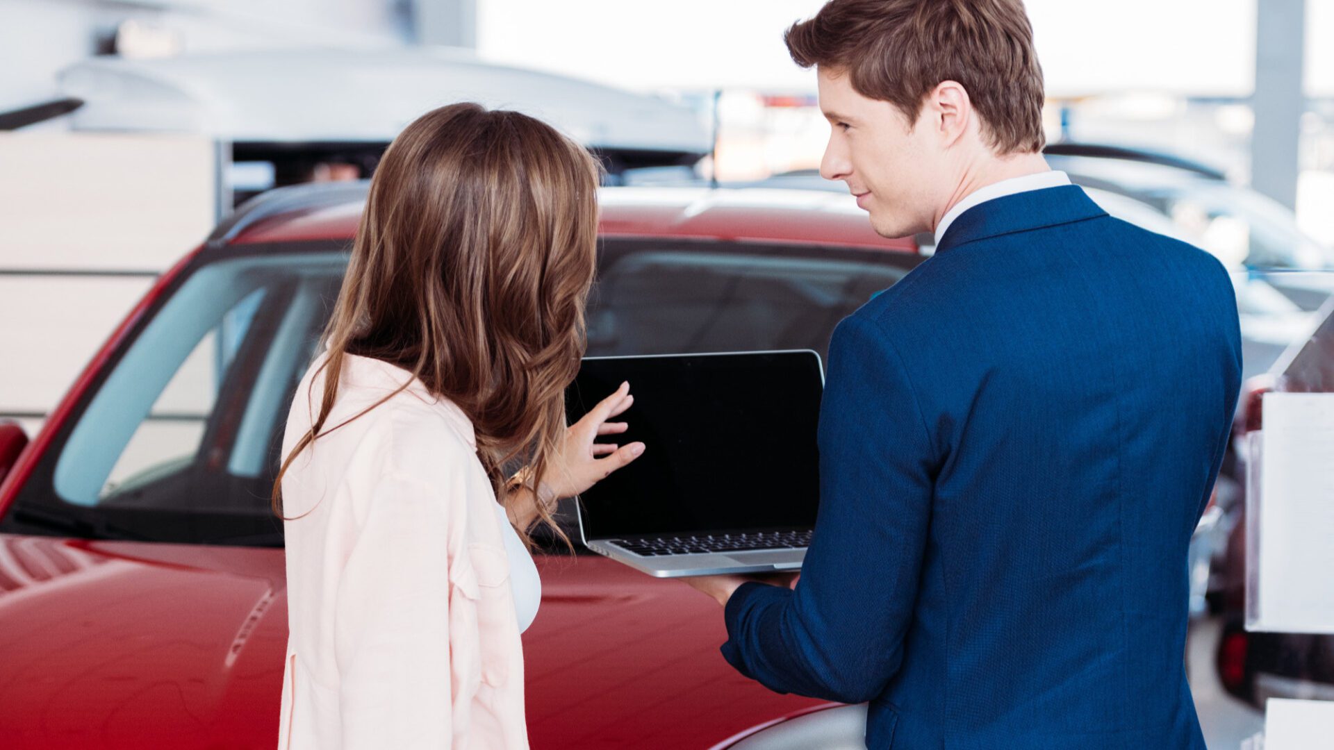 A man and woman looking at a laptop.