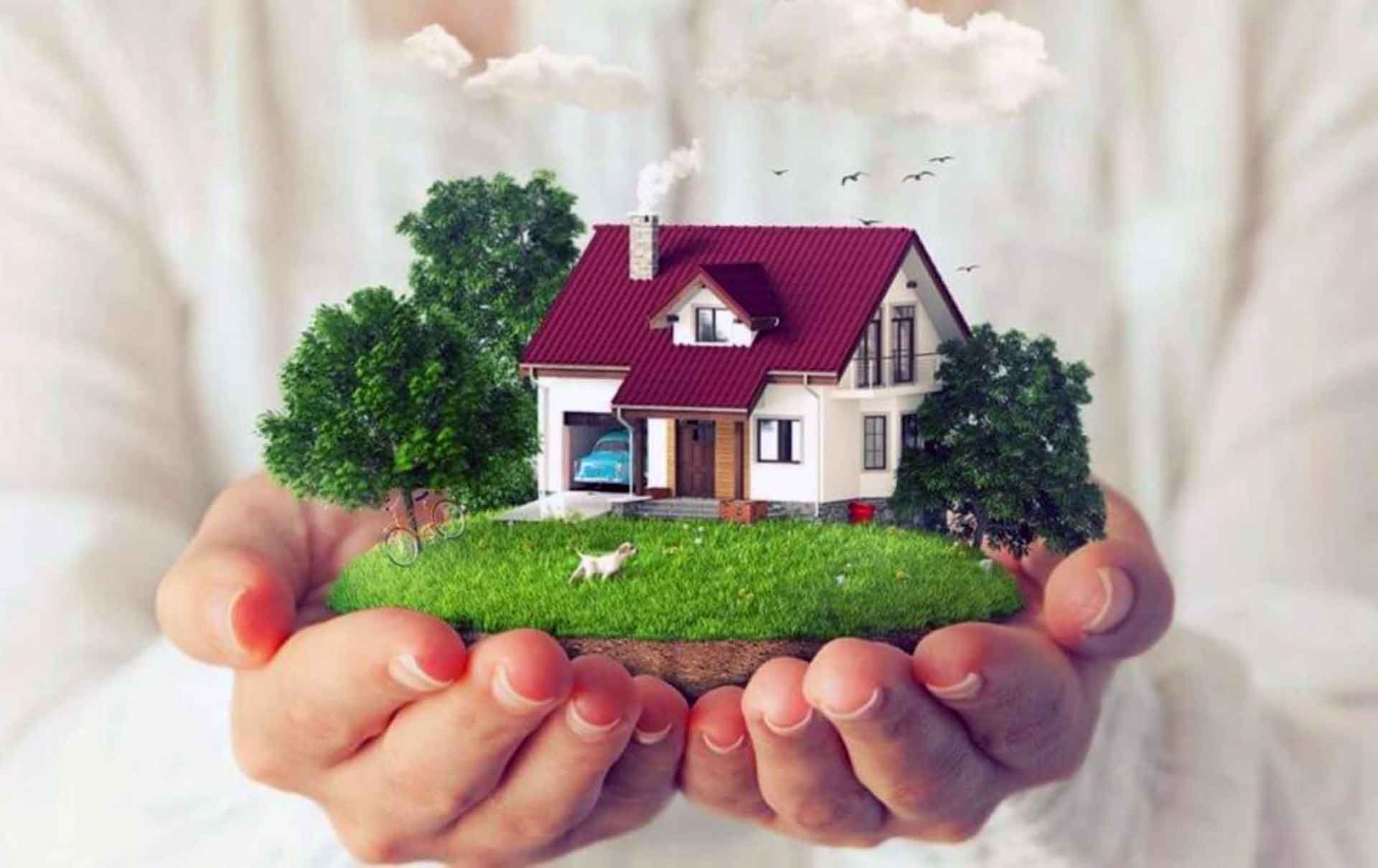 A person holding a house in their hands