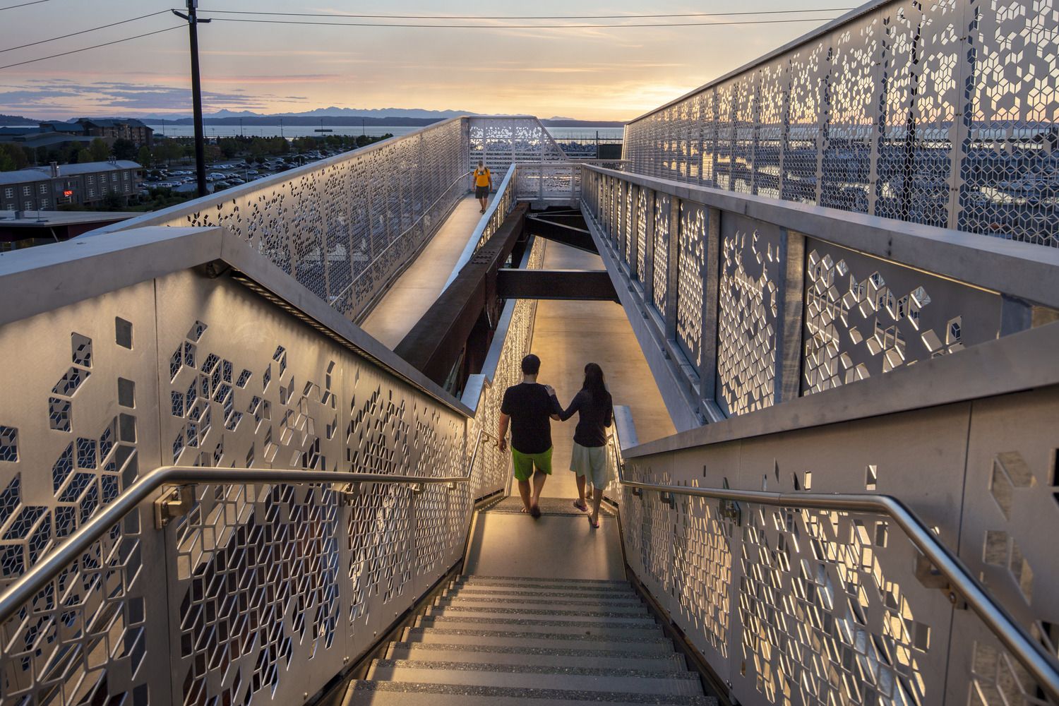 Two people walking up a set of stairs.