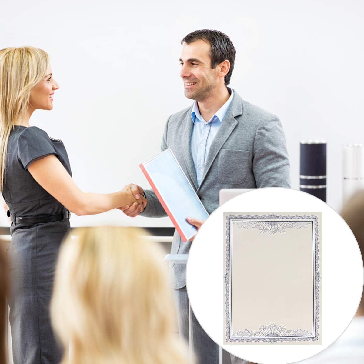 A man and woman shaking hands in front of an audience.