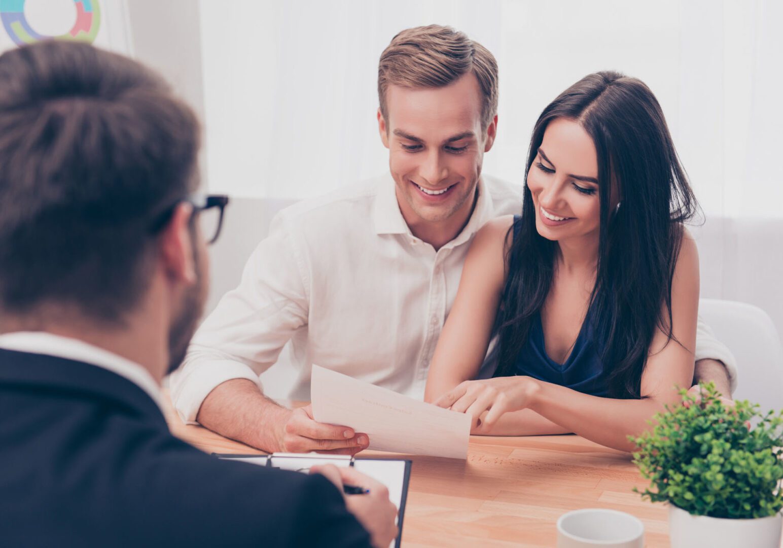 A man and woman sitting at a table with an advisor.