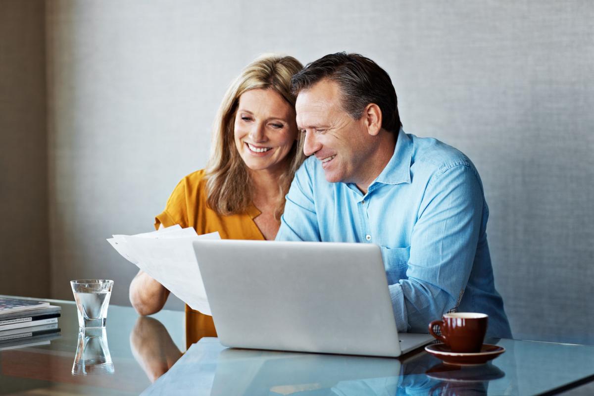 A man and woman looking at a laptop