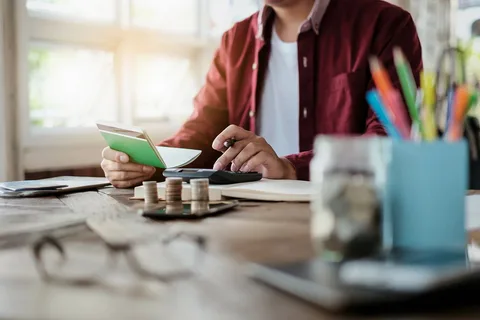 A person sitting at a table with some books