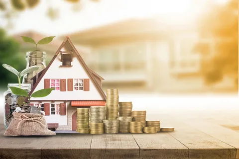 A house sitting on top of coins.